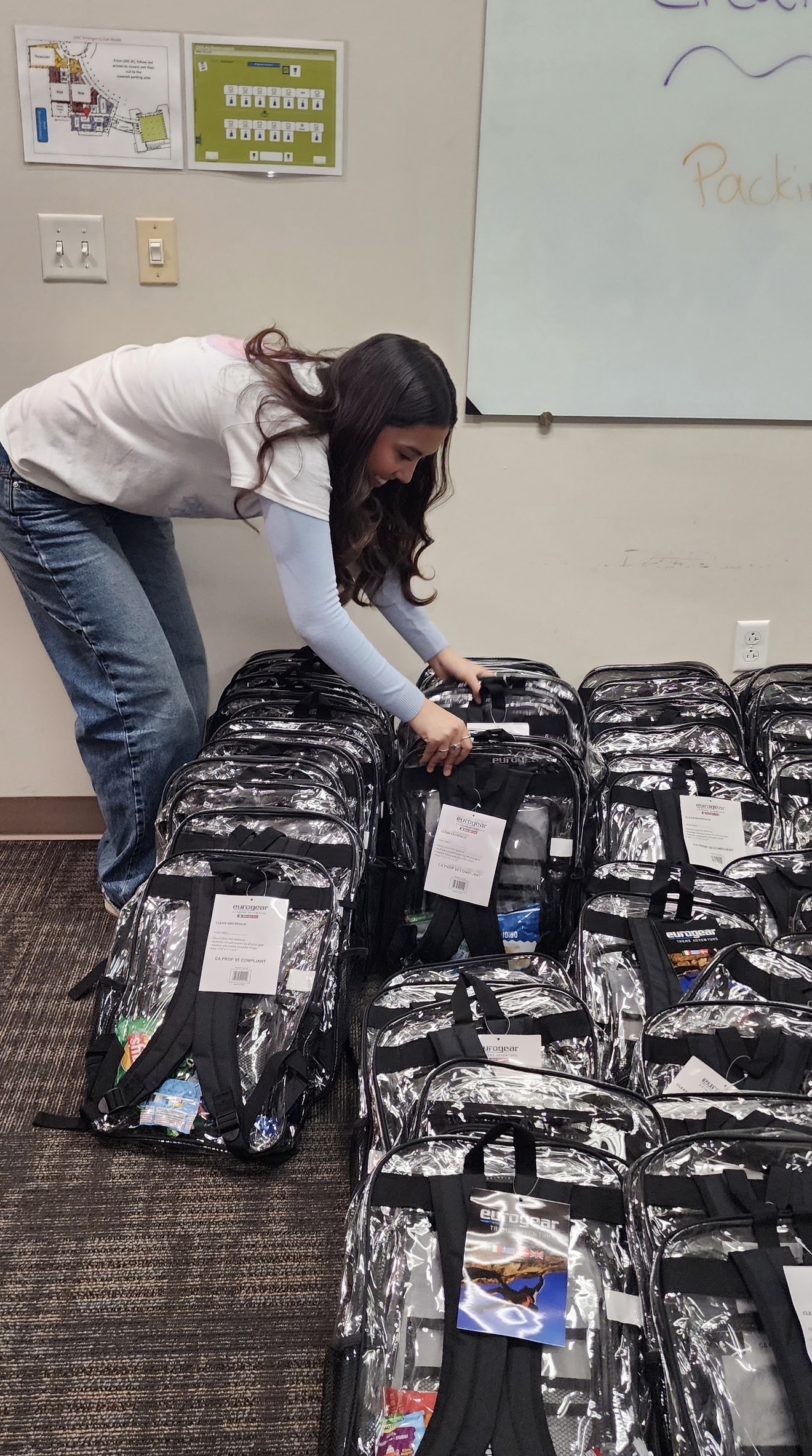 Aiyana organizing completed backpacks