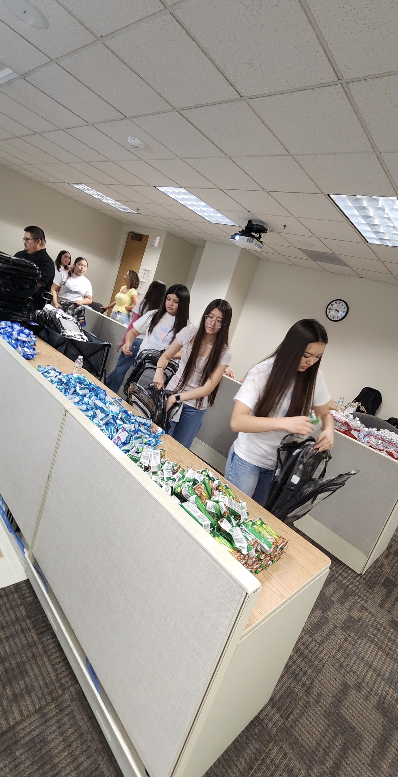 Youth volunteers packing supplies into backpacks