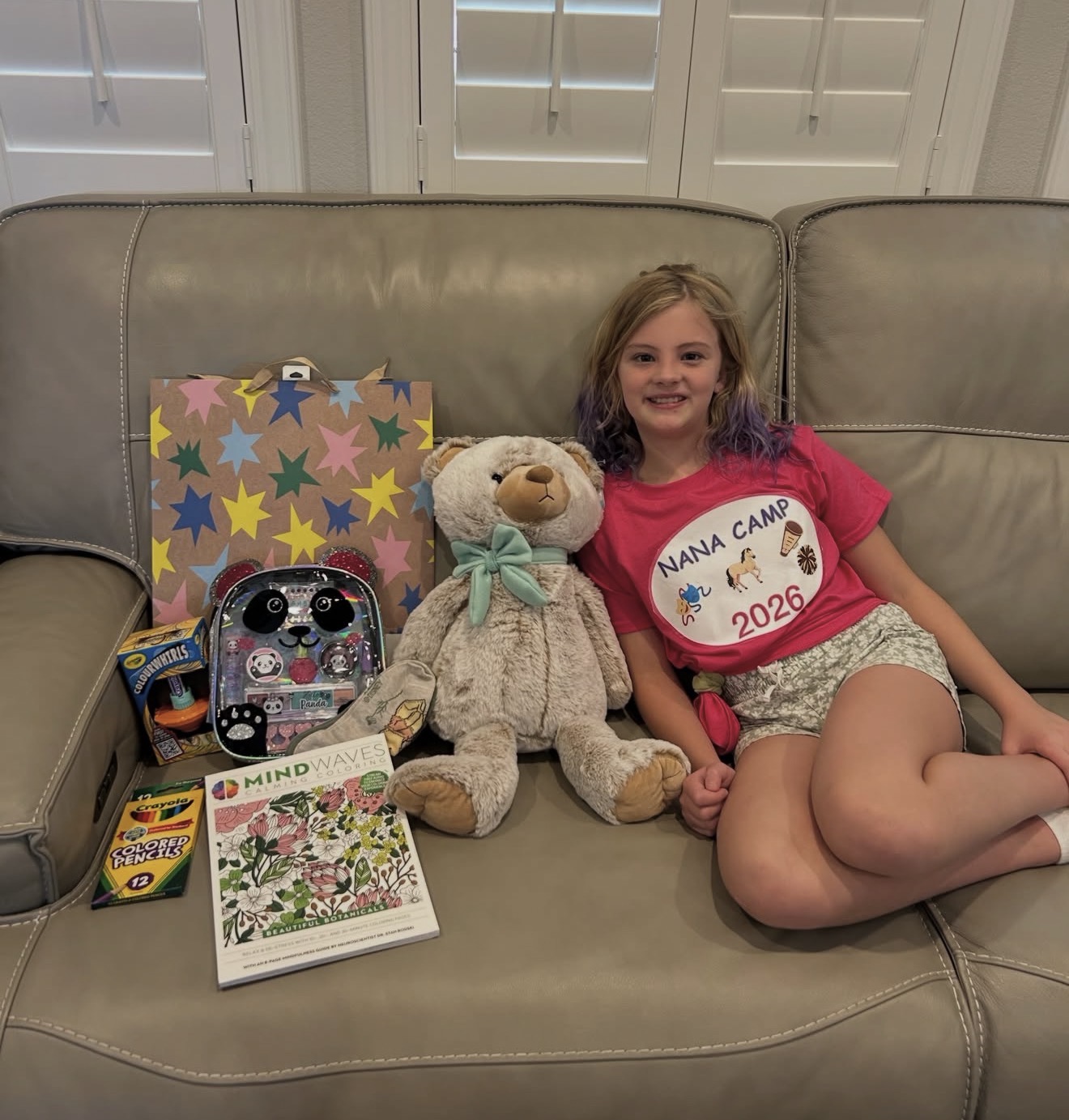 Child surrounded by personalized birthday gifts