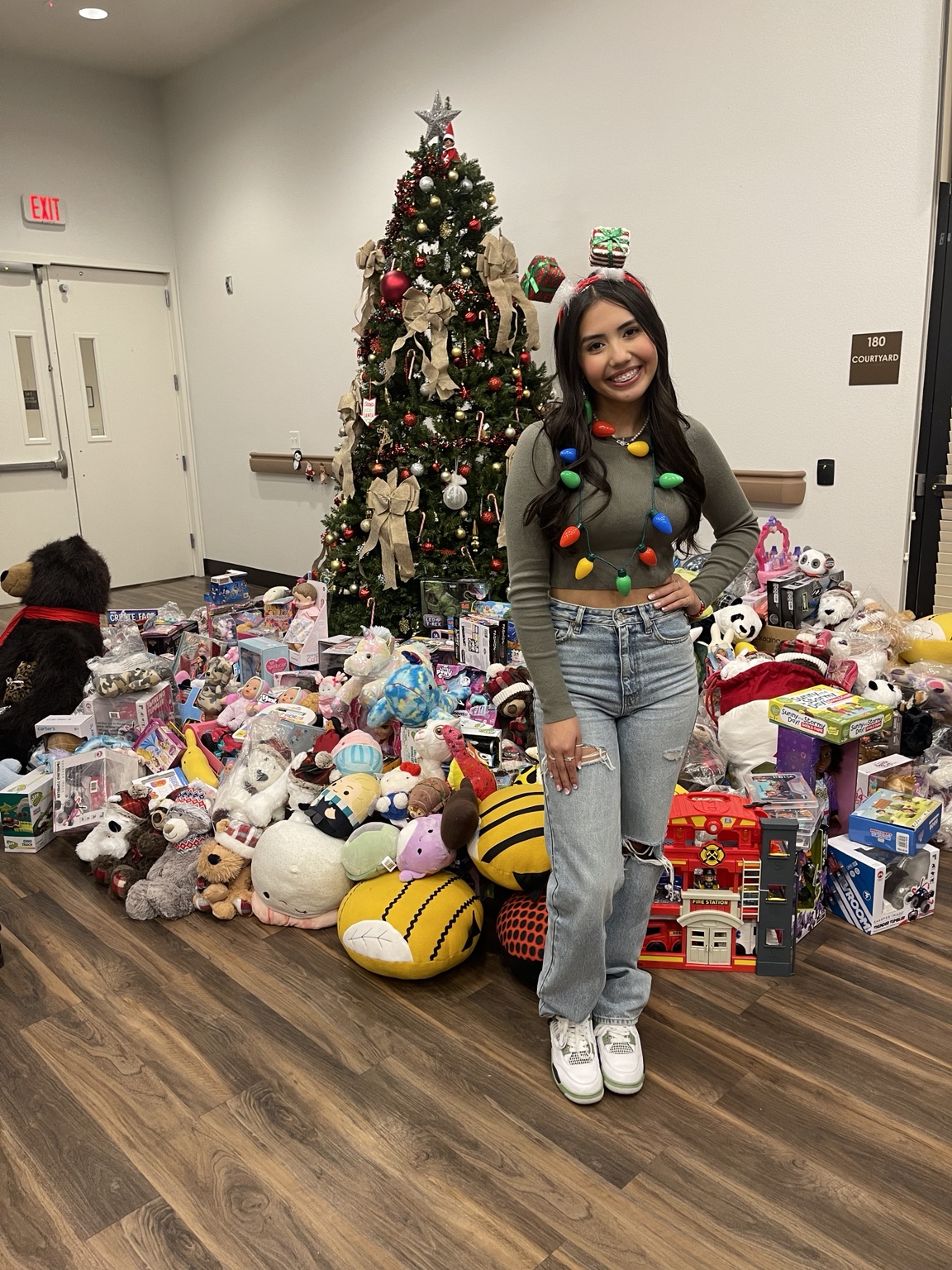 Aiyana beside the Hospice Christmas Blessing gifts