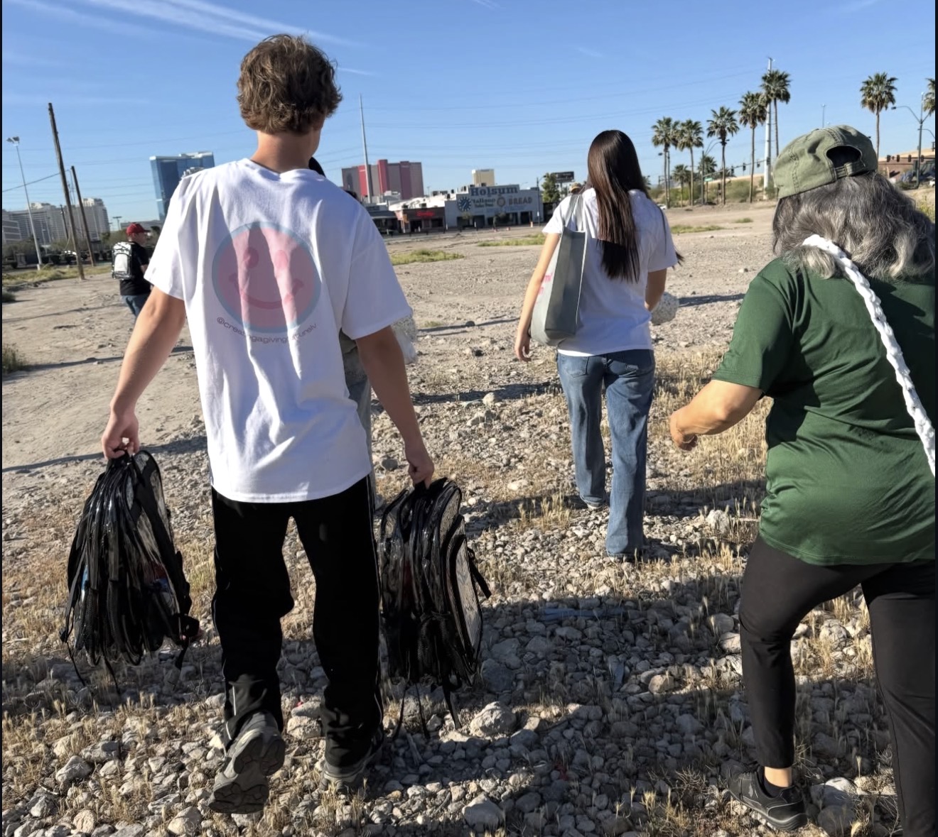 Volunteers carrying backpacks across the outreach route